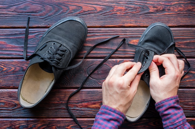 Man laces up his shoes