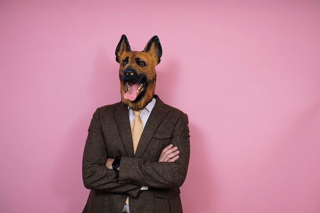 A man in a latex dog head mask with crossed arms