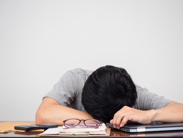 Man laying head down on working desk tried from working