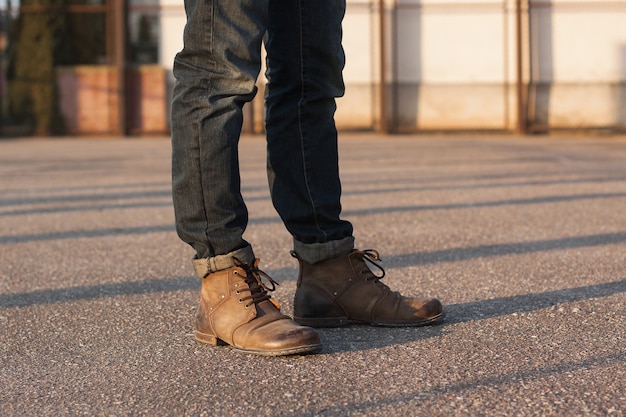 Man legs with jeans and boots