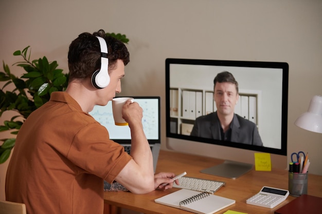 Man Listening to Colleague at Meeting