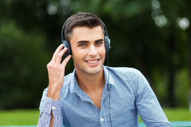     Man listening to music at the park 