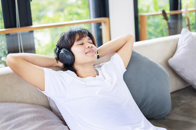 A man listening to music with wireless headphones in living room People leisure activities-Lifestyle