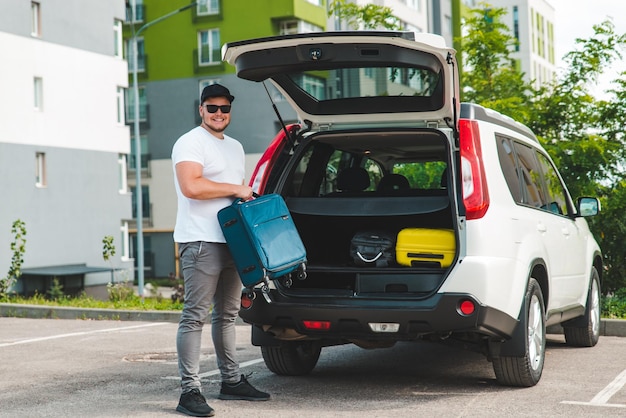 Man load bags in car trunk ready for car travel