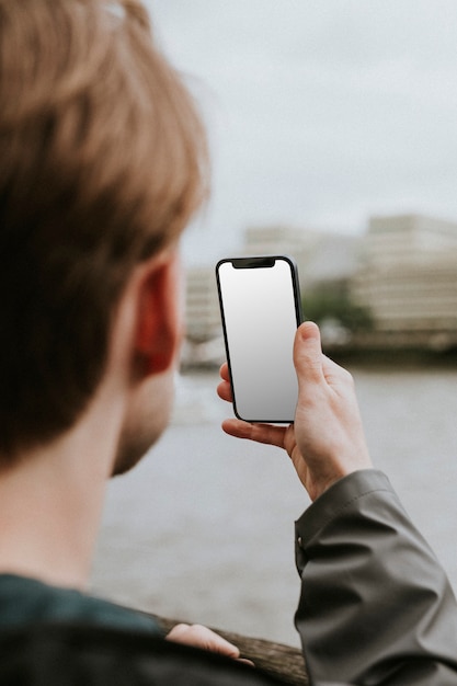 Man looking at a blank smartphone screen