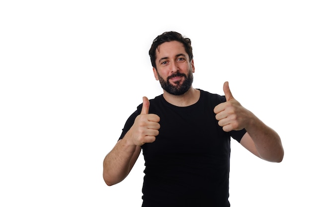 Man looking at the camera and showing thumbs up while standing on an isolated background.