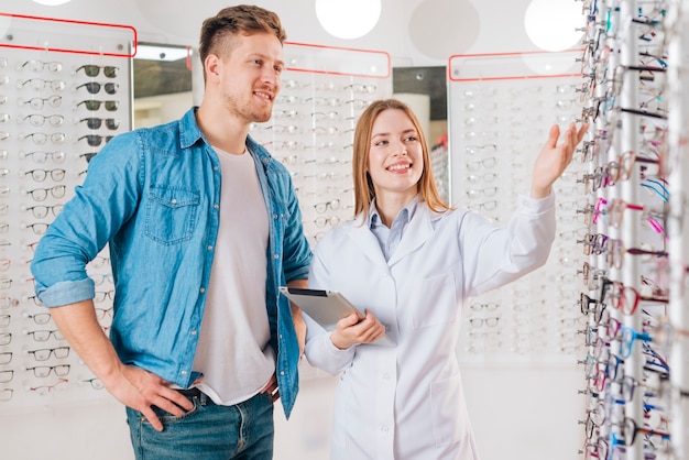 Man looking for new glasses at optometrist