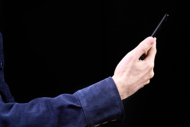 Man looking at smartphone screen on dark background