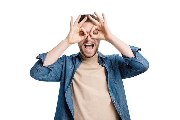 Man looking through finger glasses