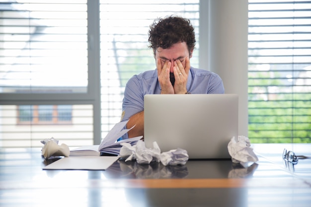 Man looking tired while working