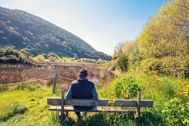 A man looks at the picturesque wildlife Natural Reserve Marisma de Joyel Cantabria Spain