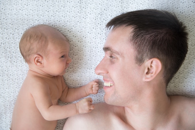 Man lying in bed with a baby