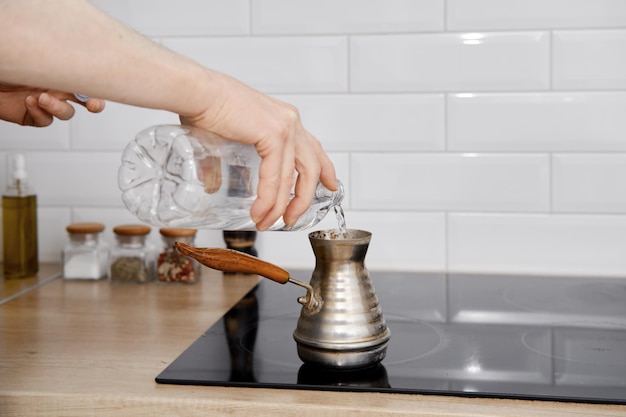 Man makes coffee in cezve