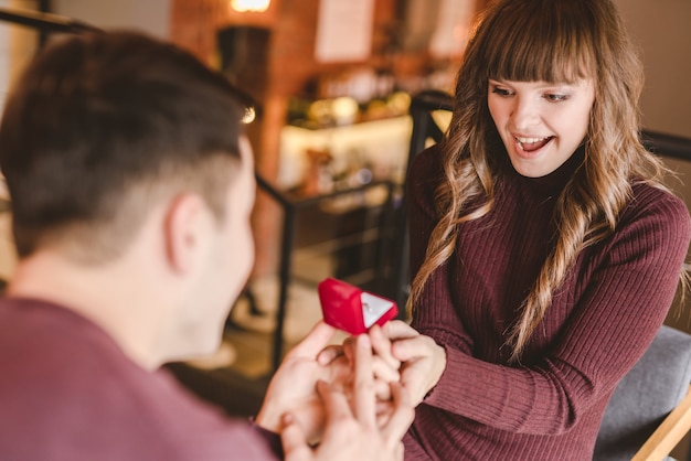 The man makes a proposal to his happy girlfriend