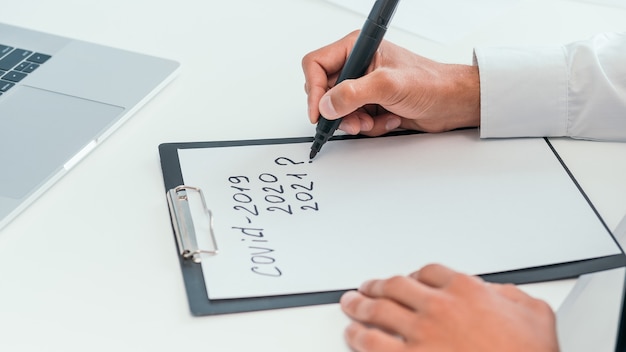 Man making marks in the clipboard