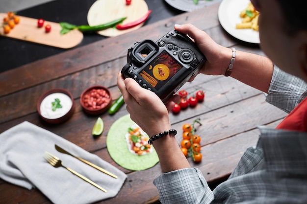 Photo man making photo of food on camera