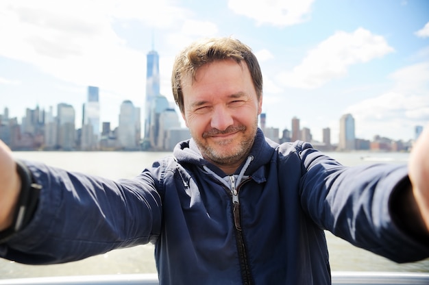 Man making selfie with Manhattan skyscrapers in New York City