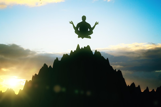 Man meditating on mountain top