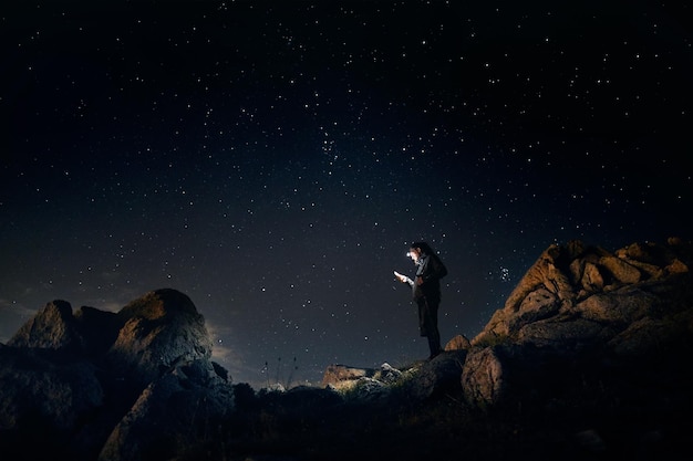 Man in mountains with night sky