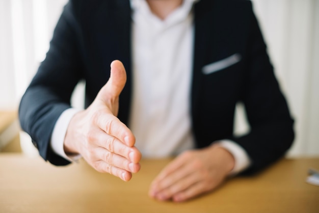 Man offering hand in office