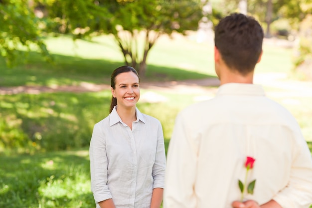 Man offering a rose to his girlfriend