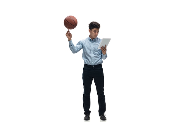 Man in office clothes playing basketball on white background