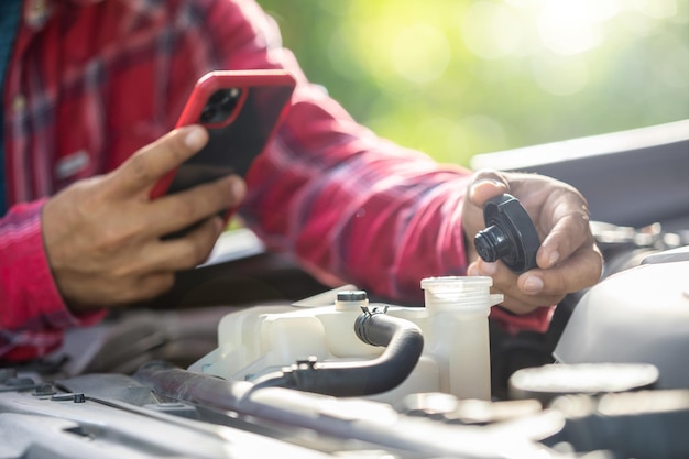 Man opening cap of car radiator to checking up the engine before start the trip Car maintenance or check up concept