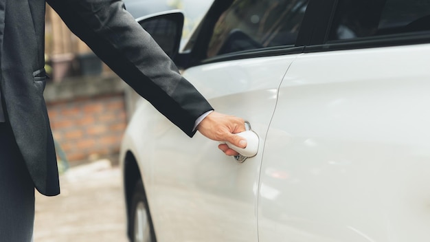 Man opening car doors to drive to work using vehicles to travel safely on the road and respecting traffic rules Safety driving concept