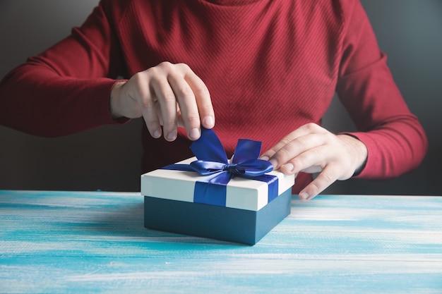 Man opens a gift on the table