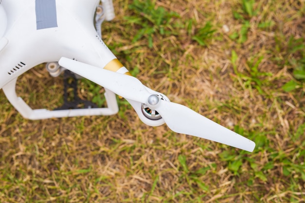 Man Operating Drone Flying or Hovering by Remote Control in Nature