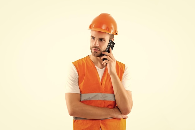 Man in orange reflective vest and helmet speak on phone isolated on white public services