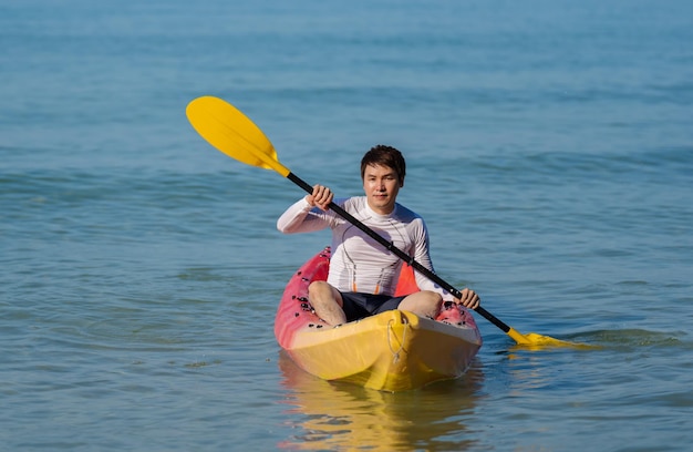 Man paddling a kayak boat in the sea