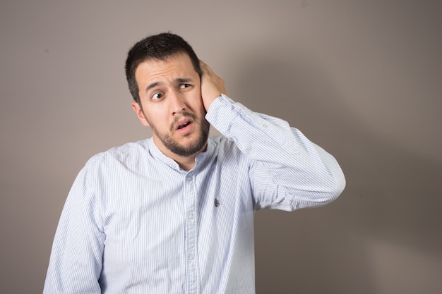 Man in pain throwing his hand to his face