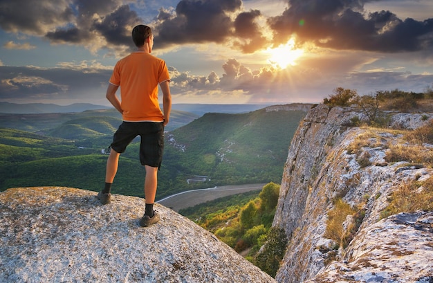 Man on peak of mountain