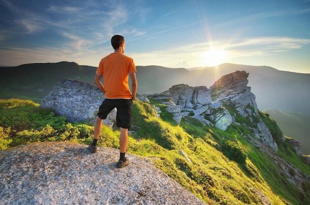 Man on peak of mountain