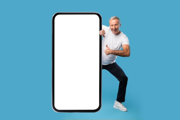 Man peeping out big white empty smartphone screen mockup