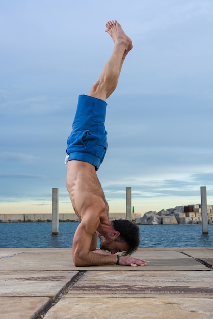 Man performing advanced yoga exercises and stretching.