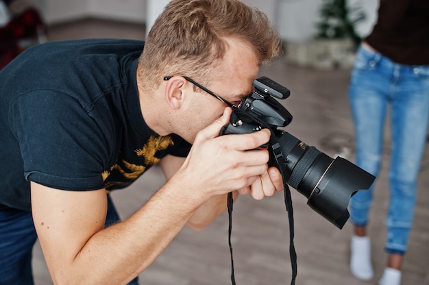 Man photographer shooting on studio. Professional photographer on work.