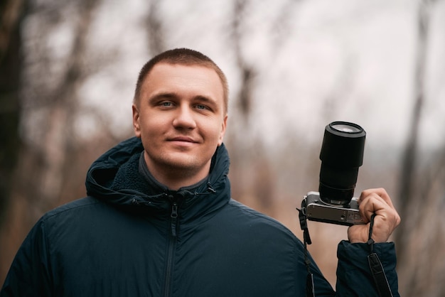 Man photographer with modern mirrorless camera outdoor Photographer website banner concept