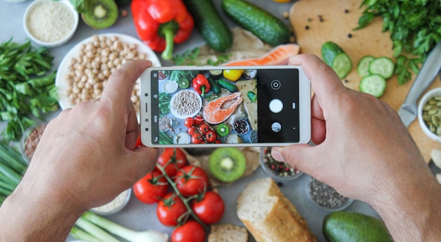 Man photographing food ingredients for balanced healthy diet