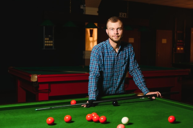 Man playing billiards in a club