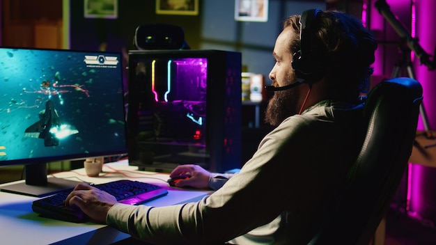 Man playing entertaining videogame with online friends flying spaceship through galaxy together