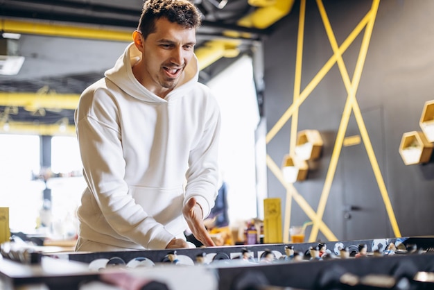 Man playing football match on table soccer