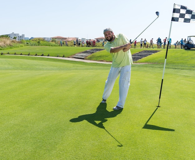 Man playing golf at club