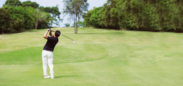 Man playing golf on a golf course panorama banner background