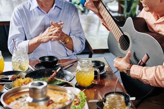 Man playing guitar at dinner