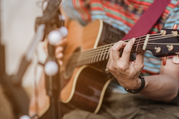 A man playing guitar on stage at a music festival.
Concert,mini concert and music festivals.