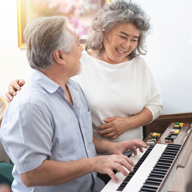 Man playing piano at home for his wife