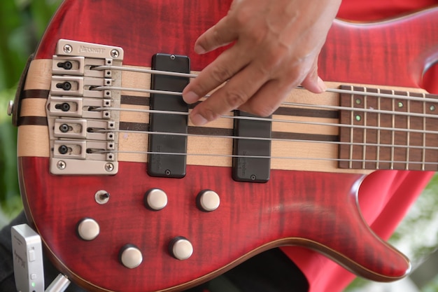 Man playing red guitar close up