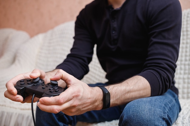 Man playing video games with a joystick in his hands